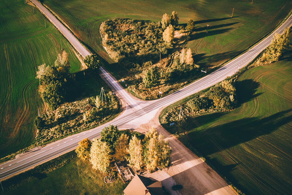 Overhead picture of green land and crossroad