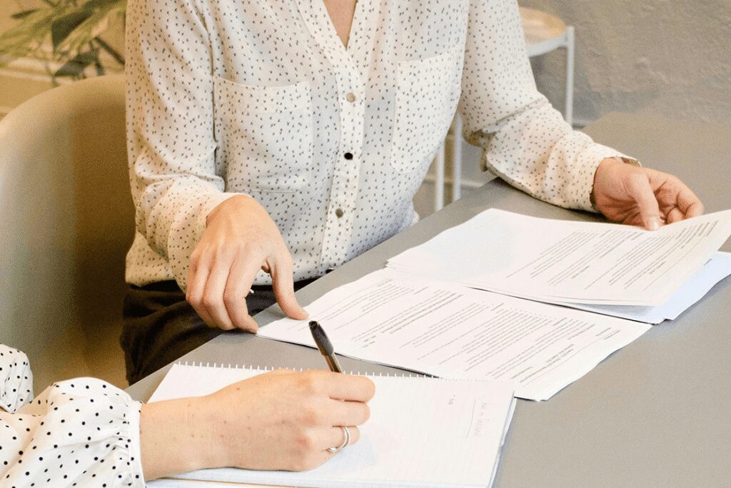female at work with paperwork, reviewing