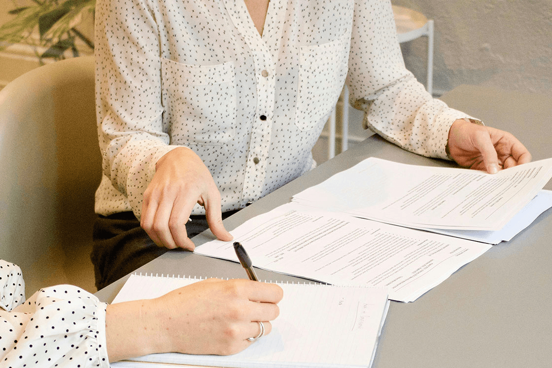 female at work with paperwork, reviewing